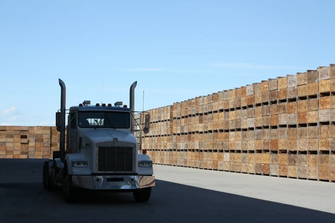 A semi truck parked in front of a wall.