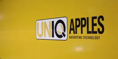 A yellow wall with the words uniq applied on it.