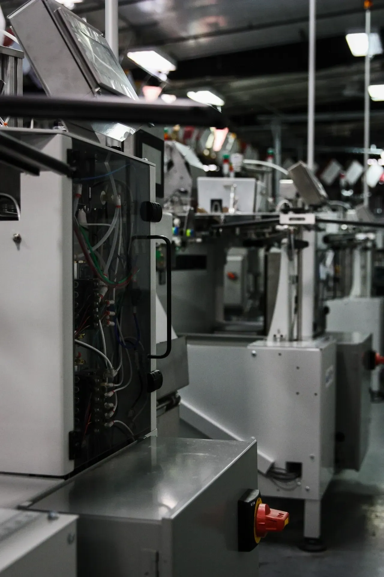 A factory floor with many machines and wires.