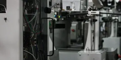 A machine in a factory with wires and cables.