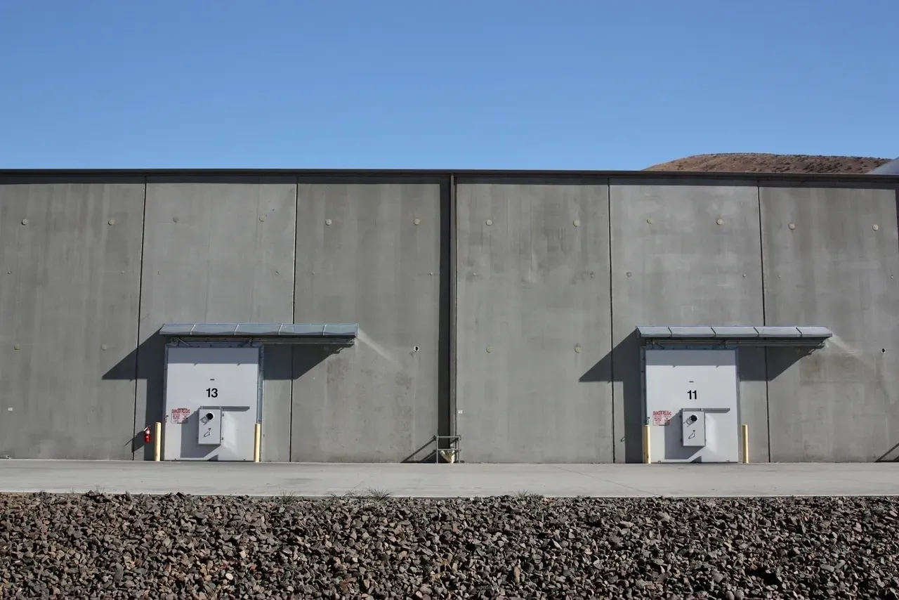 A building with two doors and a sky background